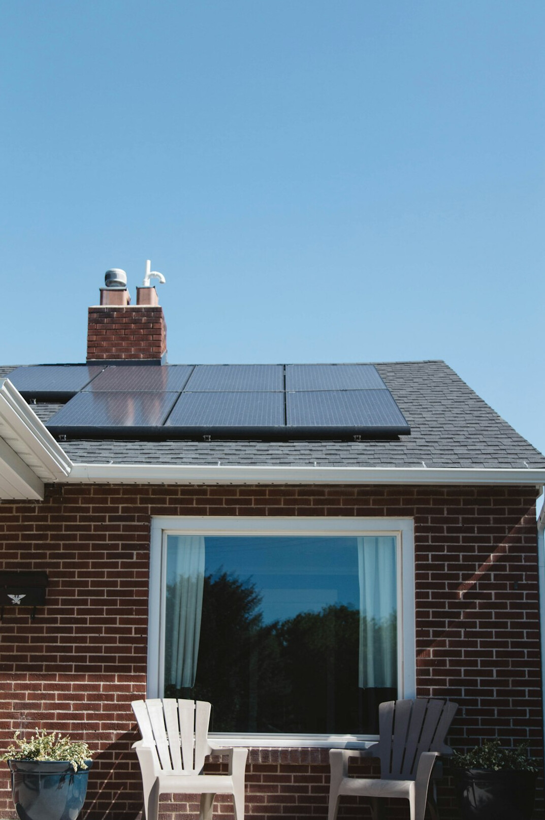 House roof with solar panels oriented toward the sun