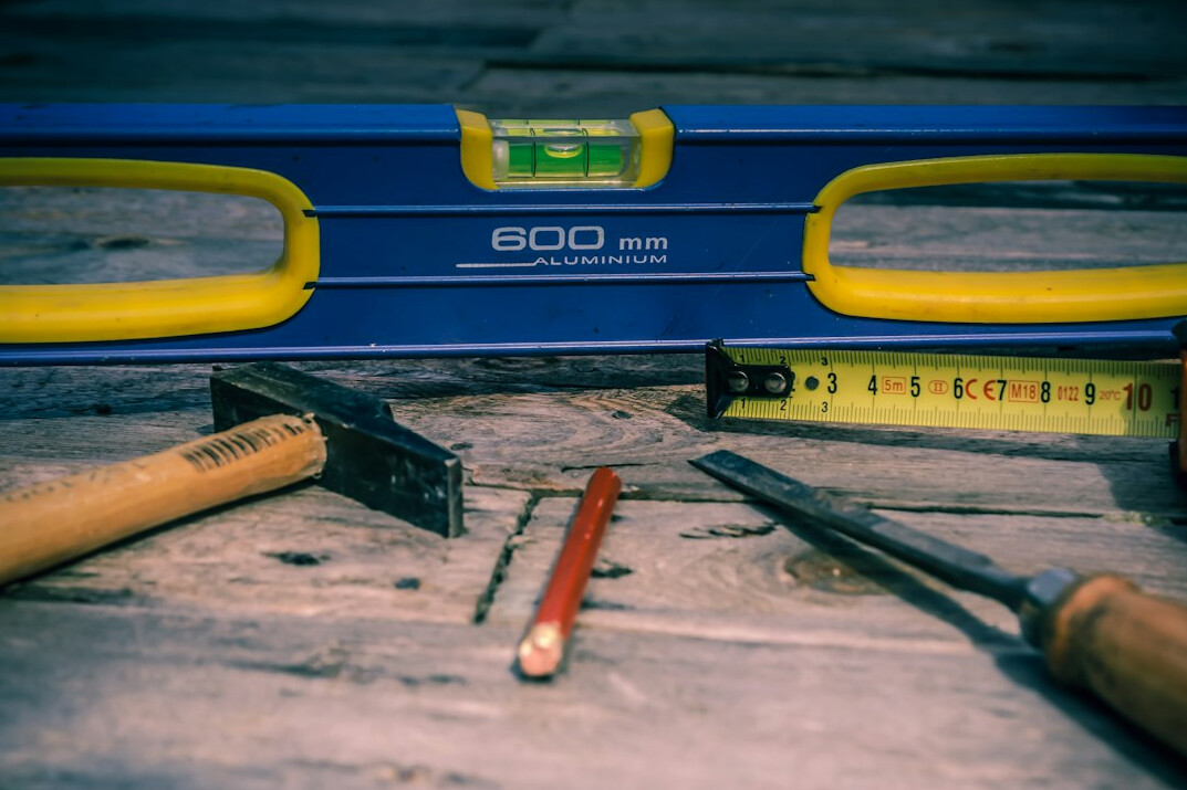 Roof plans and a spirit level on a desk